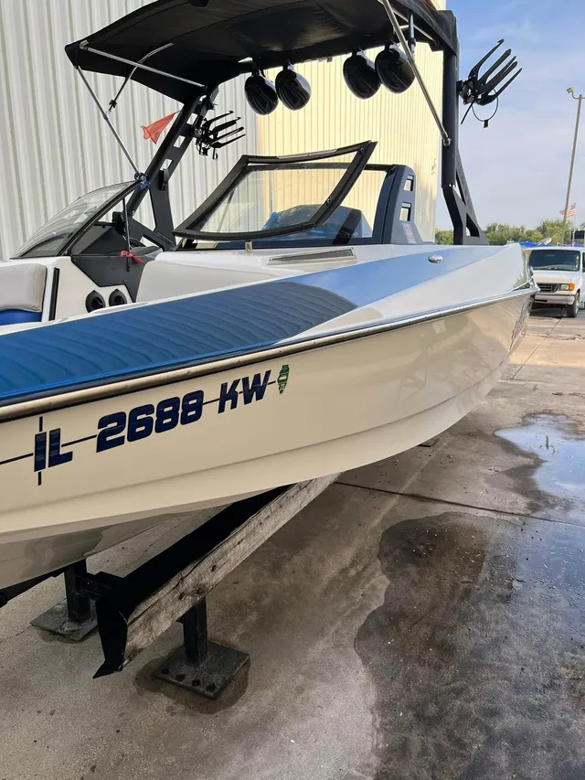 White and blue ski boat with polished hull